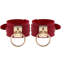 Leather red handcuffs, buckle and circles of gold color