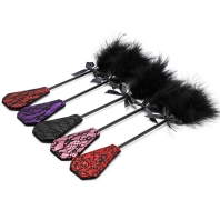 Black tickler with ribbon, red velvet and lace spanking paddle